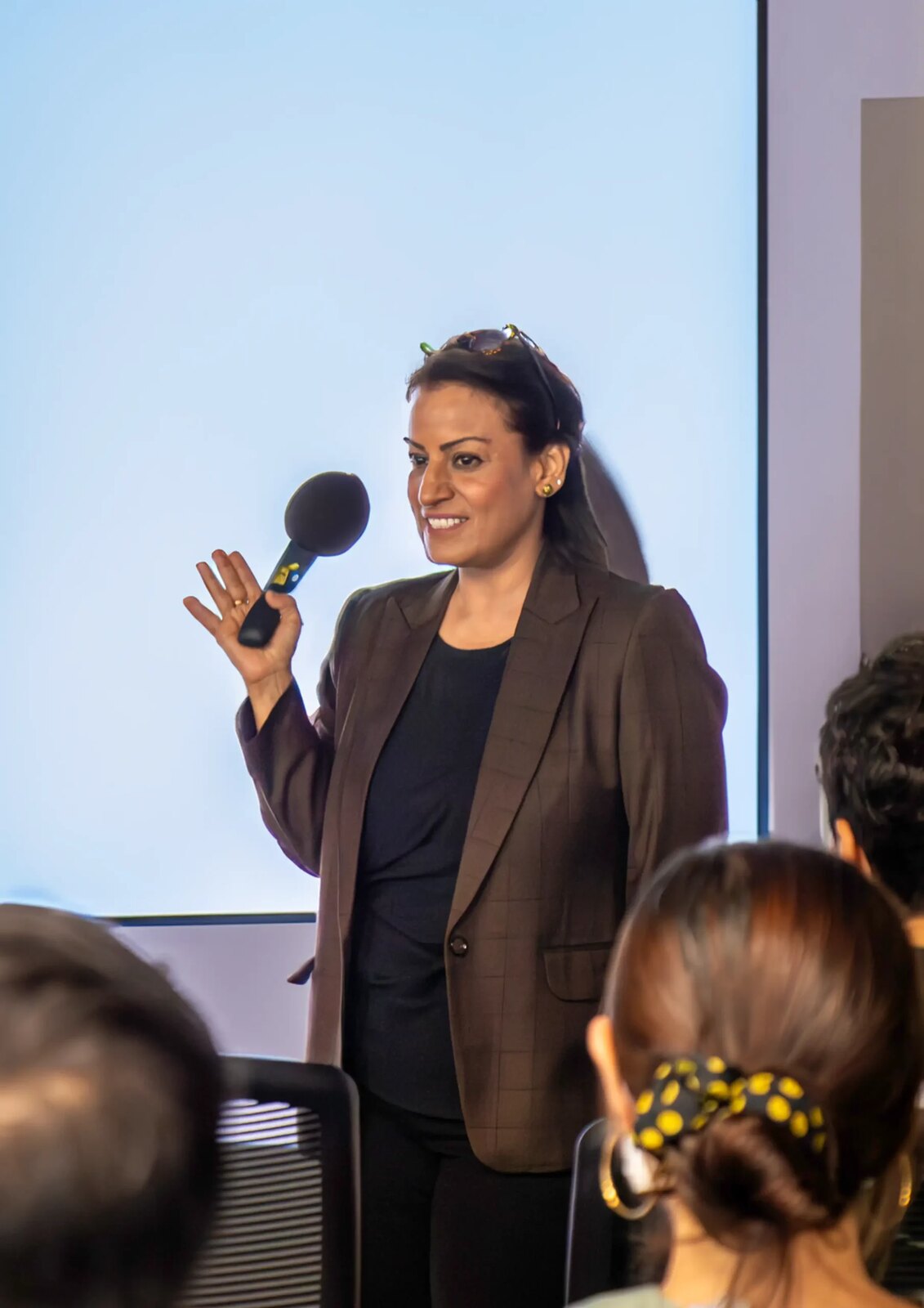 Jass Malaney speaking on stage